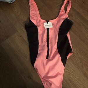 Pink and black bodysuit. Brand new